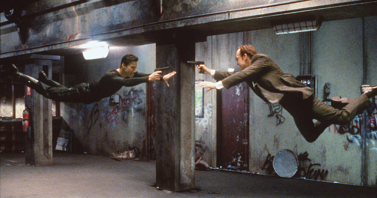 Fight and flight? Resistance fighter Neo (Keanu Reeves) and agent Smith (Hugo Weaving) face off in a subway station in The Matrix.