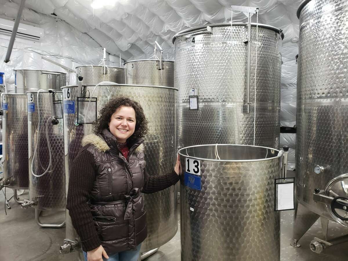 Owner Neviana Zhgaba in the winery at Aquila’s Nest Vineyards with its gleaming stainless steel tanks.