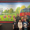 Local Firehouse Subs owners Chris and Evelyn Steinacher with their four kids - CJ, Blake, Maverick and Audrina - who are depicted in the restaurant's hand-painted mural playing soccer. The restaurant opened Monday.
