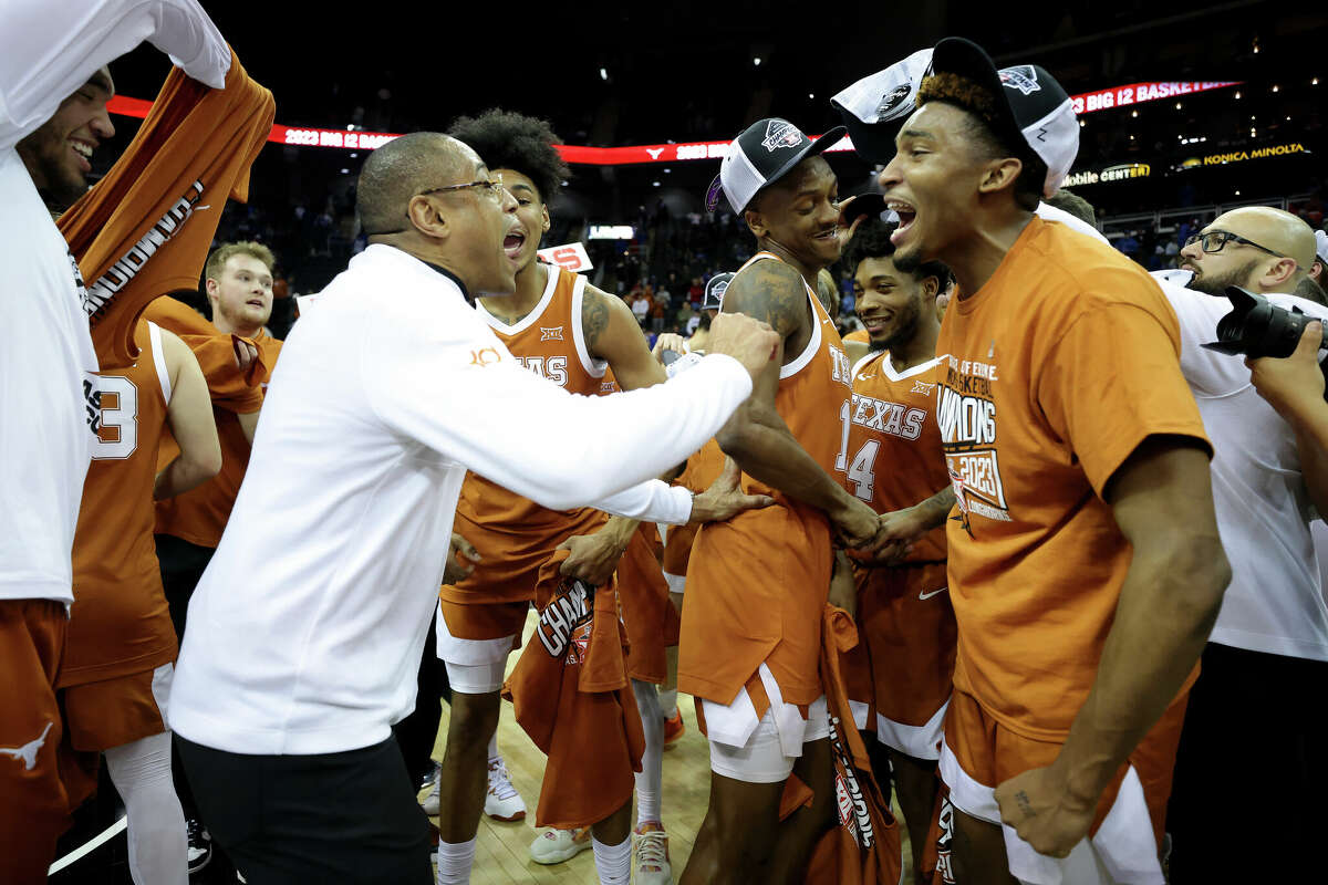 Interim head coach Rodney Terry of the Texas Longhorns celebrates with the team after defeating the Kansas Jayhawks in the Big 12 Tournament Championship game at T-Mobile Center on March 11, 2023 in Kansas City, Missouri.