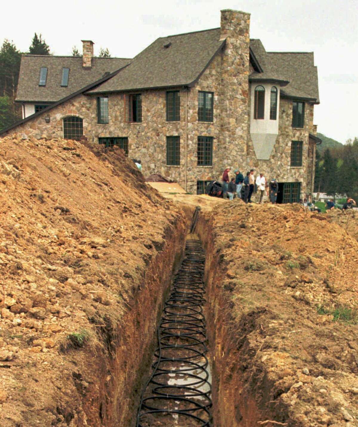 Geothermal pipes line a trench next a home in Pennsylvania. The 15,000-square-foot home will be heated and cooled using a system that extracts heat from the ground to warm it in the winter and carries heat out of the home in the summer.