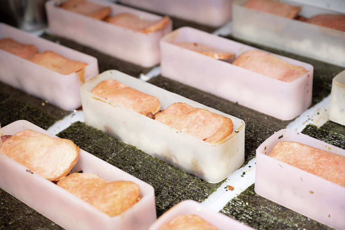Brendan Crisco making Musubi at Takahashi Market in San Mateo Calif., March 9, 2023