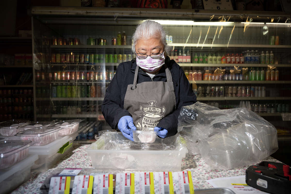 Phylis Takahashi packaging fresh Dango from Shuiei-Do (sweet Japanese rice dumplings) at Takahashi Market in San Mateo Calif., March 9, 2023