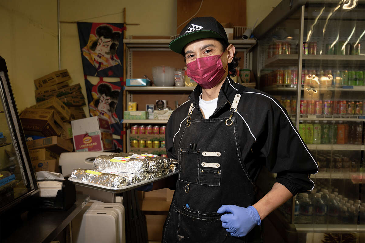 Ryan Jandu stocking musubi at Takahashi Market in San Mateo, Calif., March 9, 2023.