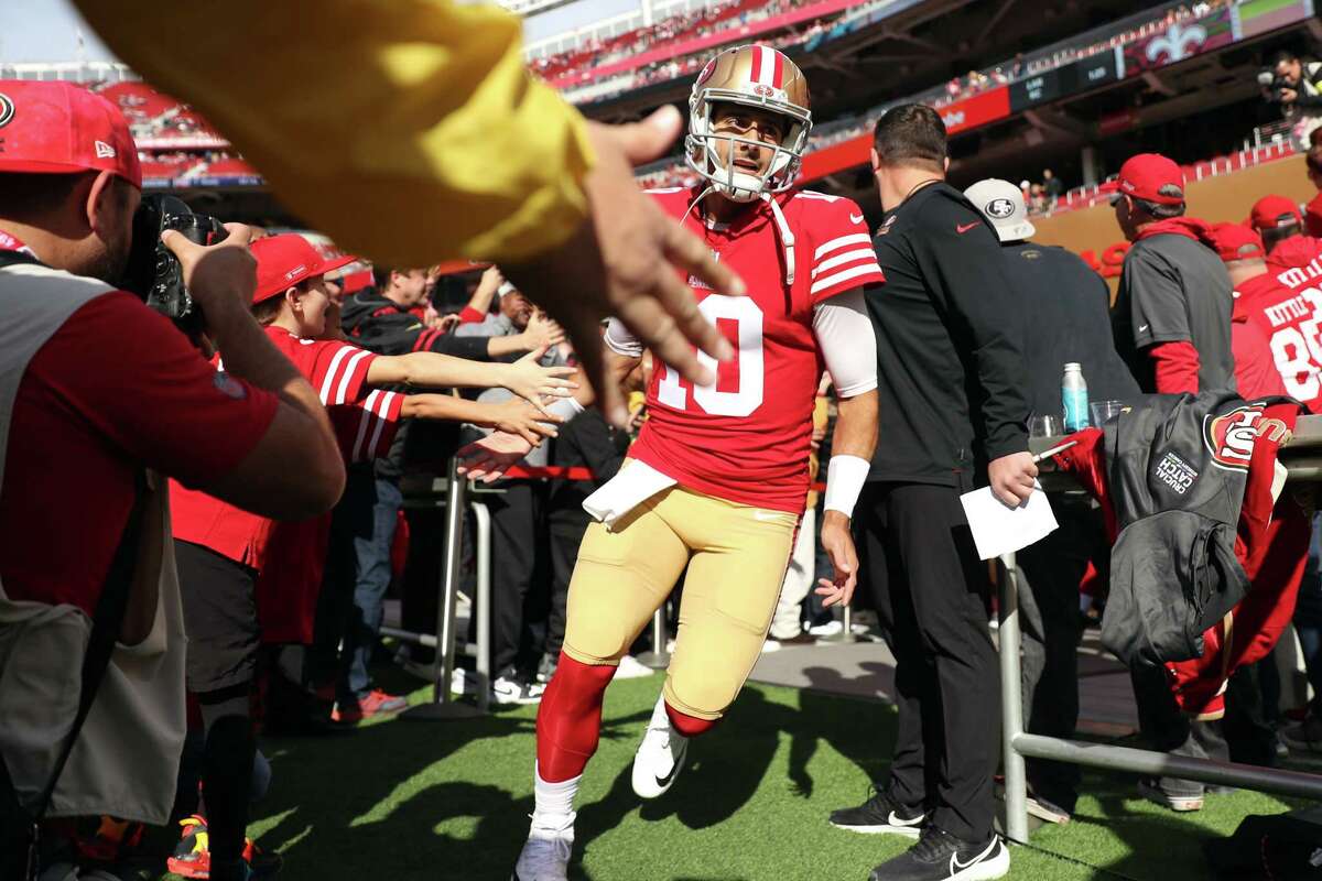 San Francisco 49ers’ Jimmy Garoppolo runs onto the field to warm up before playing New Orleans Saints during NFL game at Levi’s Stadium in Santa Clara, Calif., on Sunday, November 27, 2022.