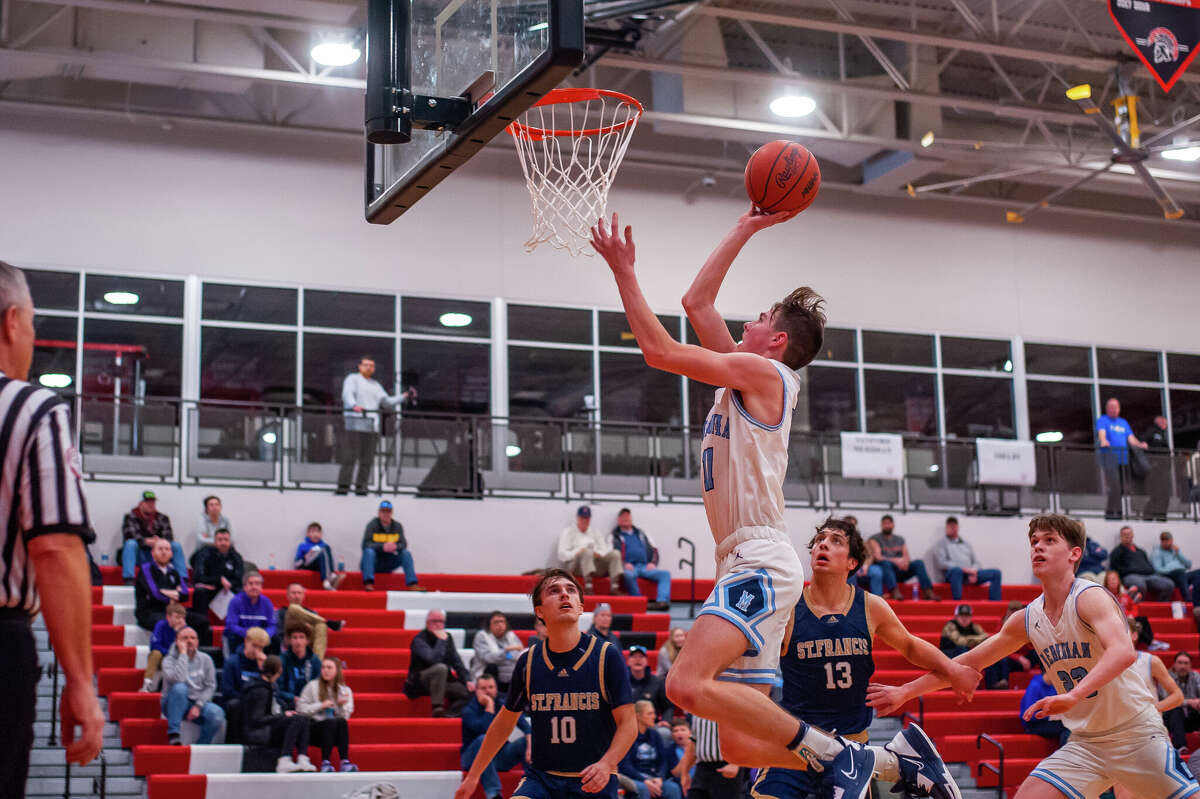 Meridian's Nick Metzger soars to the rim during Monday's regional semifinal against Traverse City St. Francis, March 13, 2023.