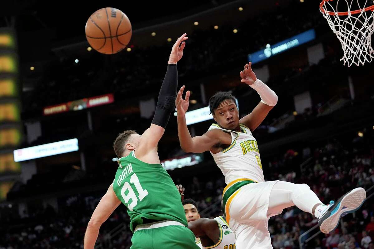 Boston Celtics' Blake Griffin (91) and Houston Rockets' TyTy Washington Jr. (0) reach for a rebound during the first half of an NBA basketball game Monday, March 13, 2023, in Houston.