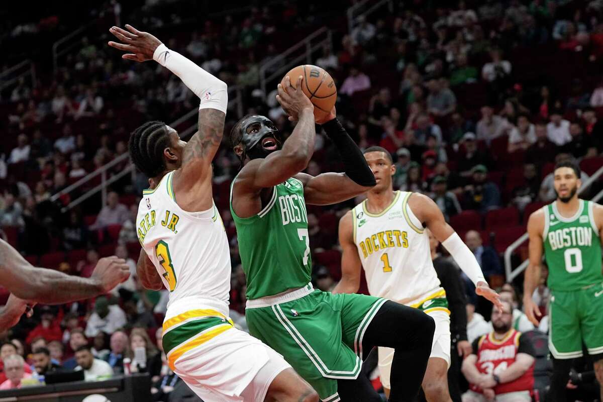 Boston Celtics' Jaylen Brown (7) goes up for a shot as Houston Rockets' Kevin Porter Jr. (3) defends during the first half of an NBA basketball game Monday, March 13, 2023, in Houston.