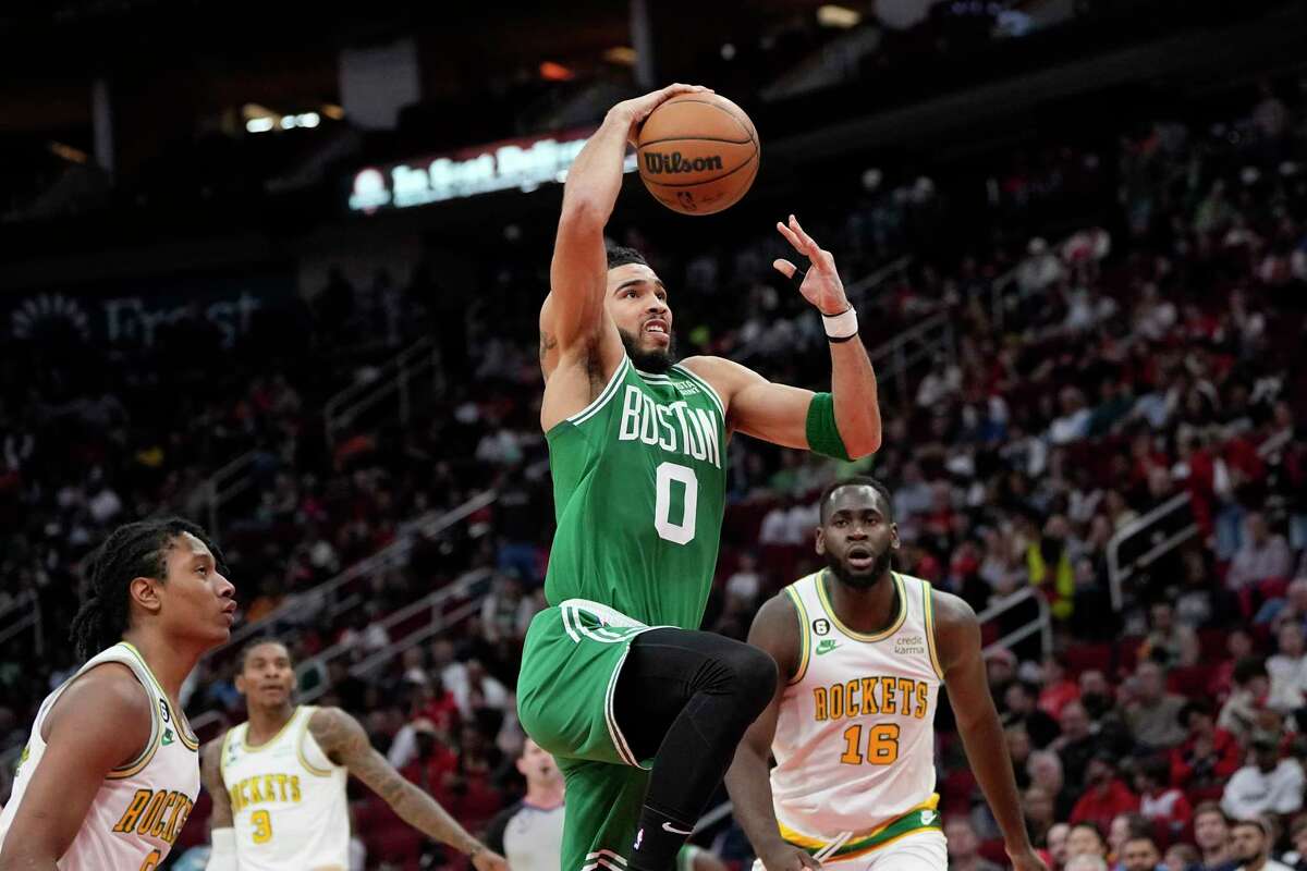 Boston Celtics' Jayson Tatum (0) goes up to attempt a dunk against the Houston Rockets during the first half of an NBA basketball game Monday, March 13, 2023, in Houston.