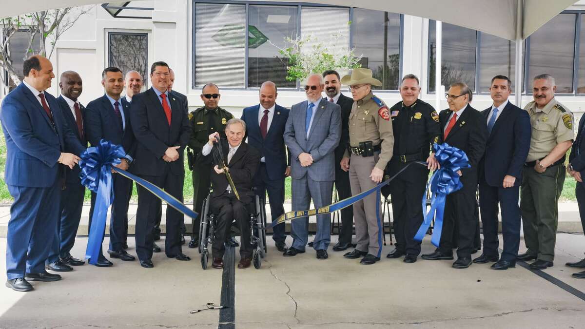 Texas Gov. Greg Abbott cuts the ribbon in front of the Laredo Police Department's new Texas Anti-Gang Center on Monday, March 13, 2023.