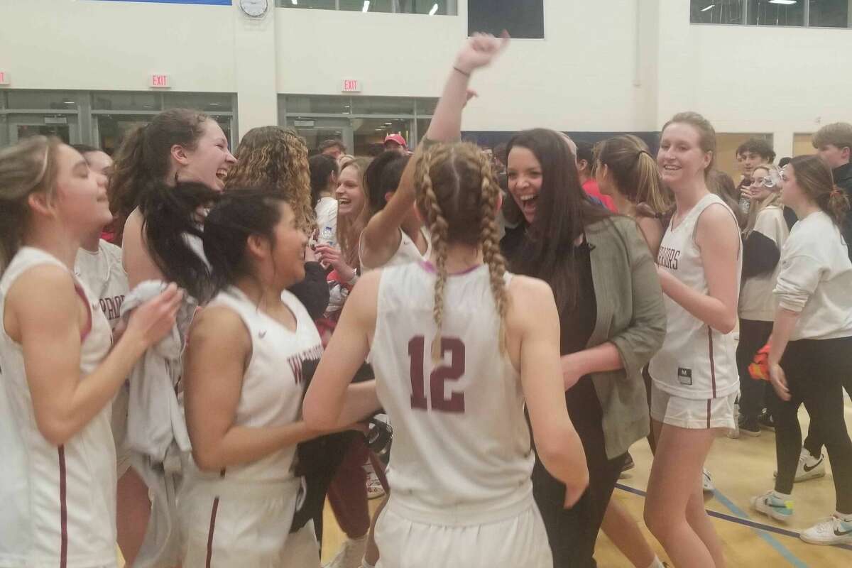 Valley Regional girls basketball coach Jaimie Bickelhaupt (second from right) celebrates with the players after the Warriors advanced to the Class M state championship game with a 56-51 win over Cromwell at Morgan High School in Clinton March 13, 2023.