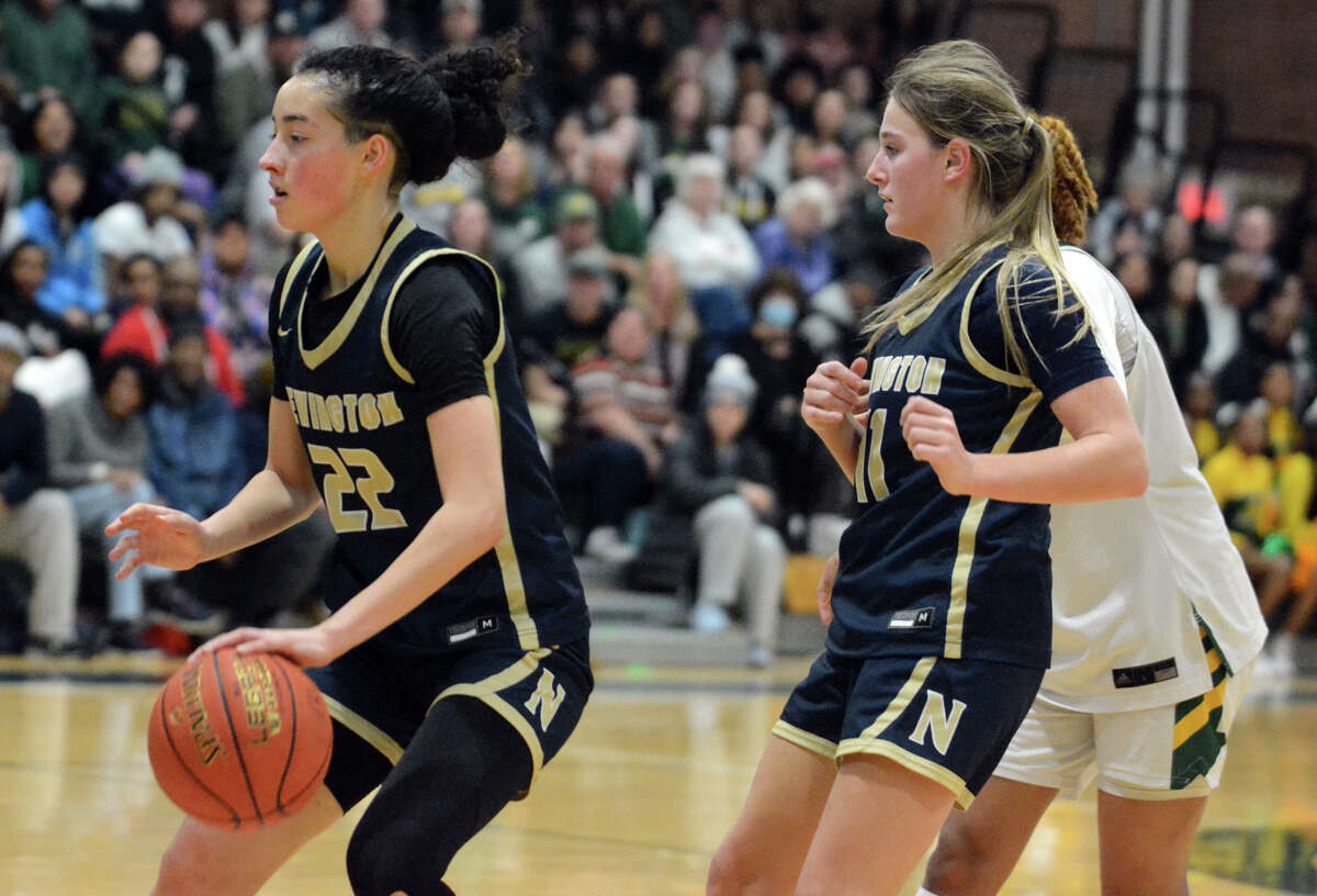 Isabella Cucuta of Newington dribbles to the hoop as Isabella Stair (11) looks on during Monday's CIAC Class LL tournament semifinal at Maloney High School in Meriden.