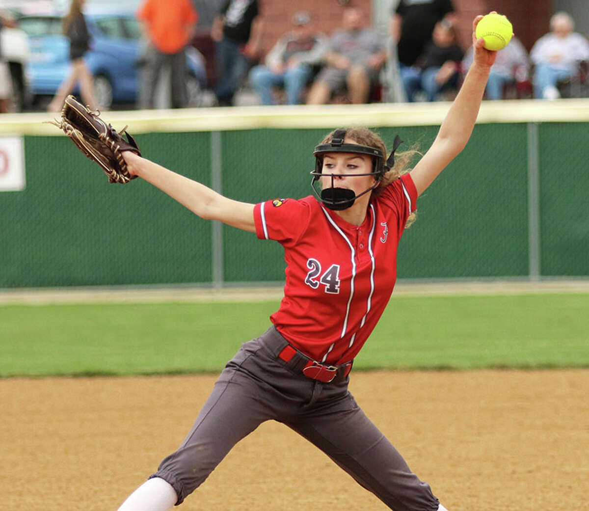 Alton pitcher Grace Presley delivers to the plate in a game last season at Alton High in Godfrey. Presley returns as ace for the Redbirds this season as a junior after striking out 160 batters in 148 innings as a sophomore.