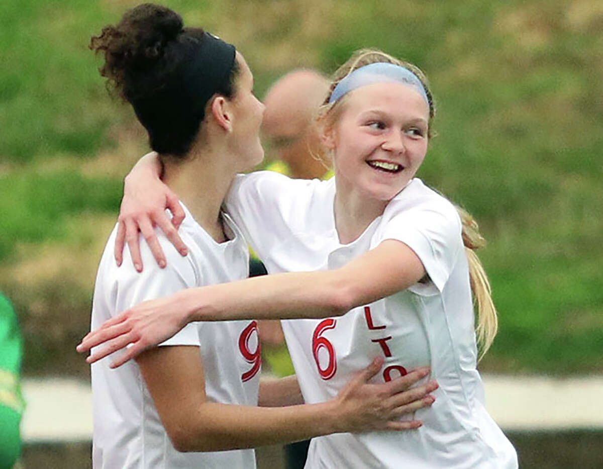 Alton's Lyndsey Miller, right,and teammate Emily Baker, left, each scored a goal in their team's 2-0 victory over Mascoutah Monday night in their season opener in a  Metro Cup Showcase game in Mascoutah.