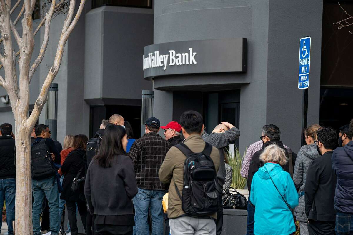 Customers in line outside Silicon Valley Bank headquarters in Santa Clara, California on March 13. The collapse of Silicon Valley Bank has prompted a global reckoning at venture capital and private equity firms, which found themselves suddenly exposed all together to the tech industry's money machine. 
