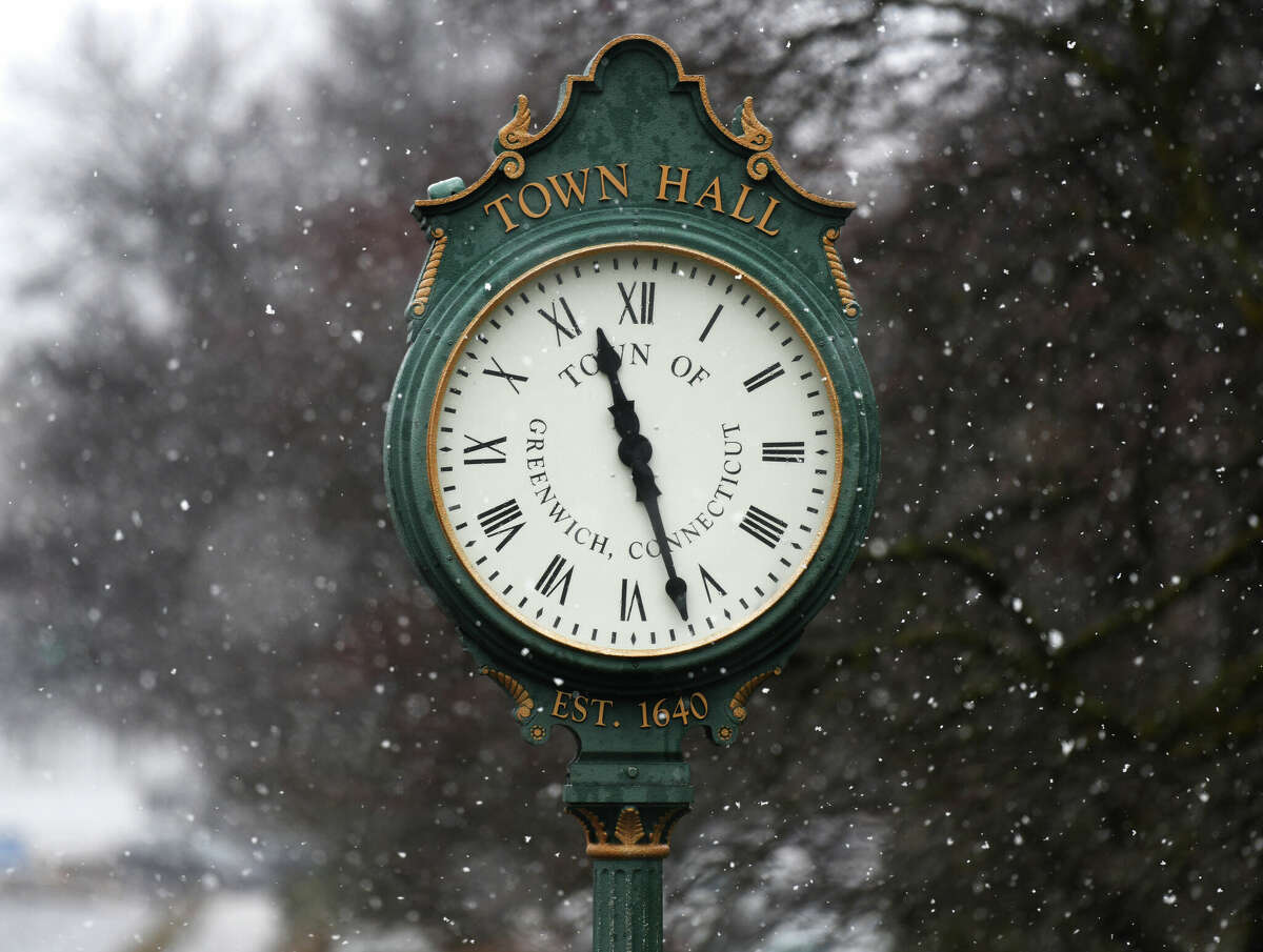 Snow falls upon the clock outside Town Hall in Greenwich, Conn. Tuesday, March 7, 2023. The area was hit with a minor storm Tuesday that produced minimal accumulations of rain and snow.