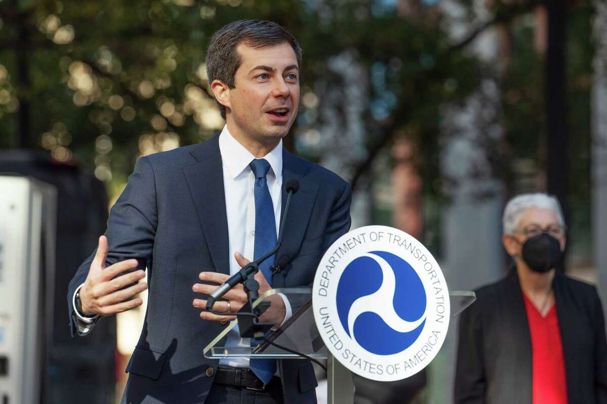 Pete Buttigieg, U.S. secretary of transportation, speaks during an electric vehicle showcase and display outside the Department of Transportation headquarters in Washington, D.C., U.S., on Wednesday, Oct. 20, 2021. The congressional bipartisan infrastructure deal includes a $7.5 billion investment in electric vehicle charging and more than $10 billion for zero and low-emission buses as part of the White House administration's effort to transition to clean energy.