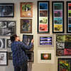 Greenwich High School photography teacher Shekaiba Bennett hangs her students' work in the Greenwich Public Schools K-12 District Art Show at the Greenwich Arts Council's Bendheim Gallery in Greenwich, Conn. Monday, March 13, 2023. Work in a variety of mediums from elementary through high school students is displayed at the gallery through March 26.