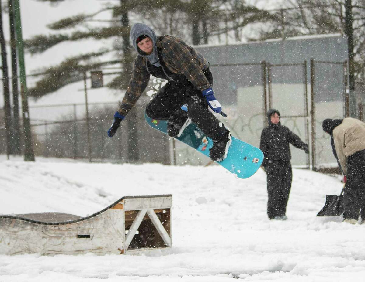 Robbie Eaton of Germantown enjoys the new snow snowboarding at the skatepark in Washington Park during a snow storm on Tuesday, March 14, 2023 in Albany, N.Y.