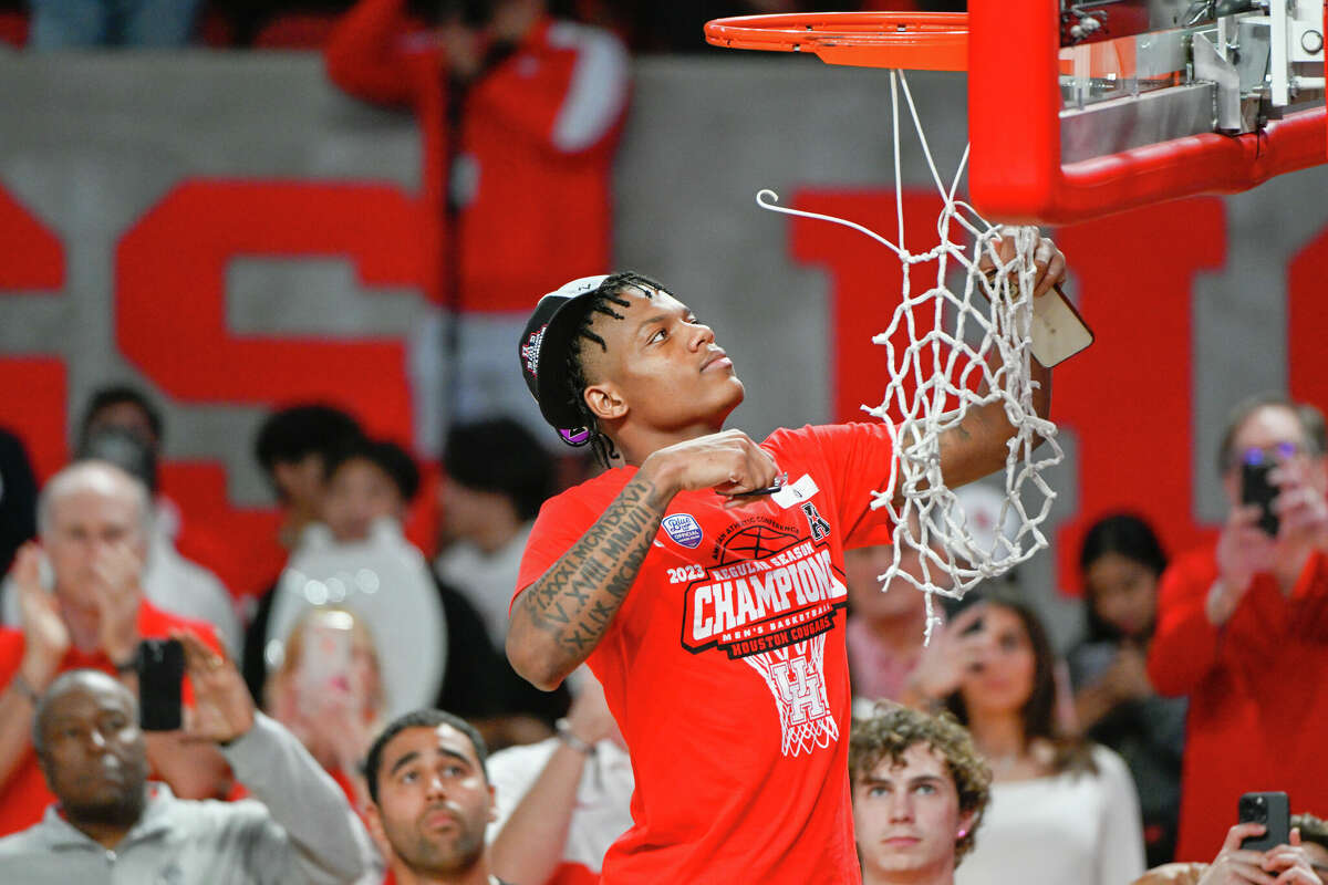 Houston Cougars guard Marcus Sasser (0) cuts down the net following the basketball game between the Wichita State Shockers and Houston Cougars at the Fertitta Center on March 2, 2023 in Houston.