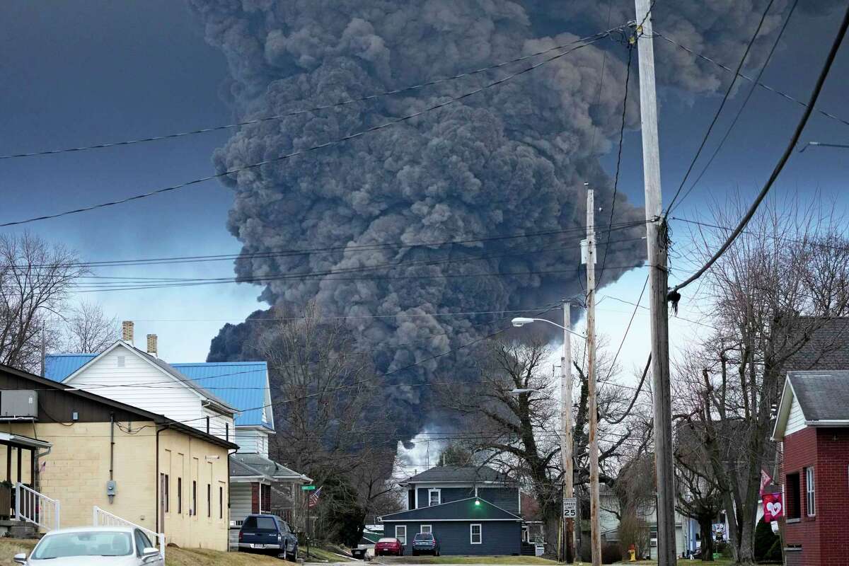 FILE - A black plume rises over East Palestine, Ohio, as a result of a controlled detonation of a portion of the derailed Norfolk Southern trains, Feb. 6, 2023. The Ohio attorney general said Tuesday, March 14, that the state filed a lawsuit against railroad Norfolk Southern to make sure it pays for the cleanup and environmental damage caused by a fiery train derailment on the Ohio-Pennsylvania border last month.