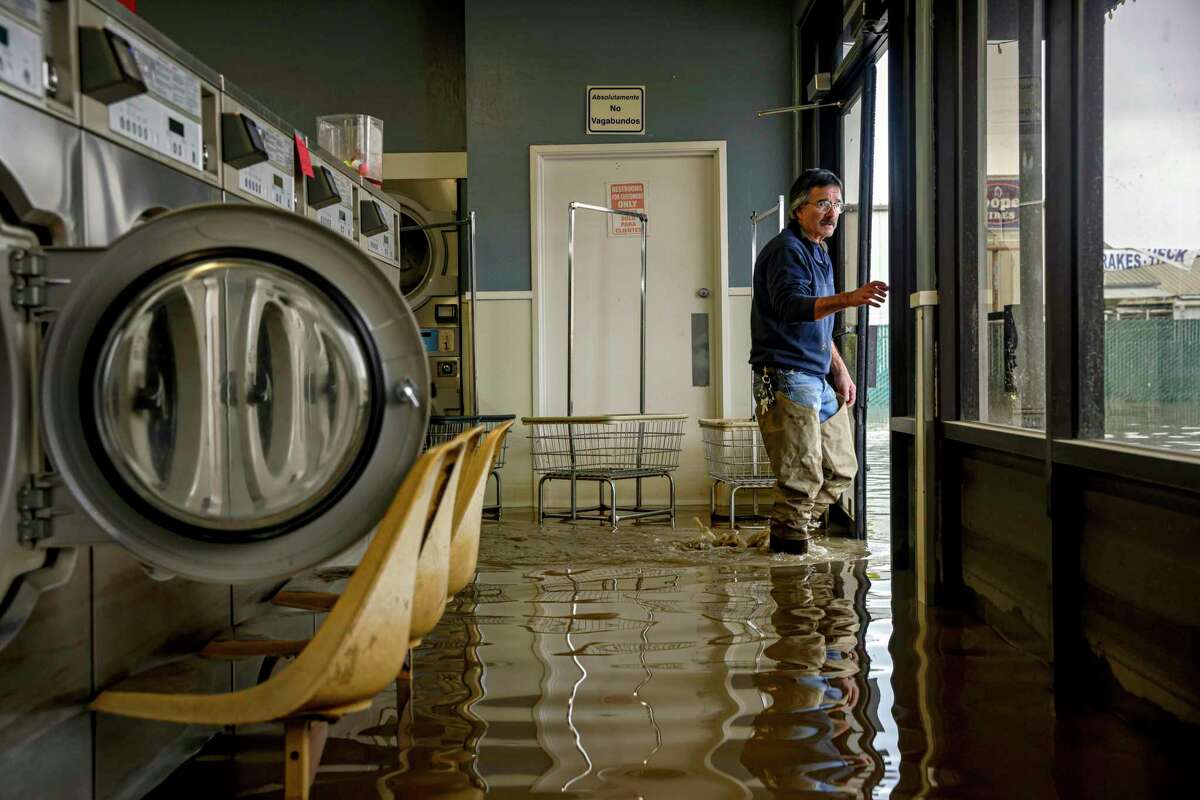 Patrick Cerruti assesses damage of his daughter’s flooded laundry mat, Pajaro Coin Laundry, on Salinas Road in Pajaro, Calif. on Tuesday, March 14, 2023. A levee failure prompted overnight evacuations on Friday, March 10, and into the next day. More than 1,000 people were forced to evacuate due to “life threatening flash flooding,” said Monterey County Sheriff’s Office. Cerruti and his wife Pamela said they were informed about the flooding and looting of their store by Monterey County Sheriff’s Office during high water rescues last weekend. The Cerrutis have since returned to the store to access damage and recover any items that weren’t stolen or ruined in the flood waters.