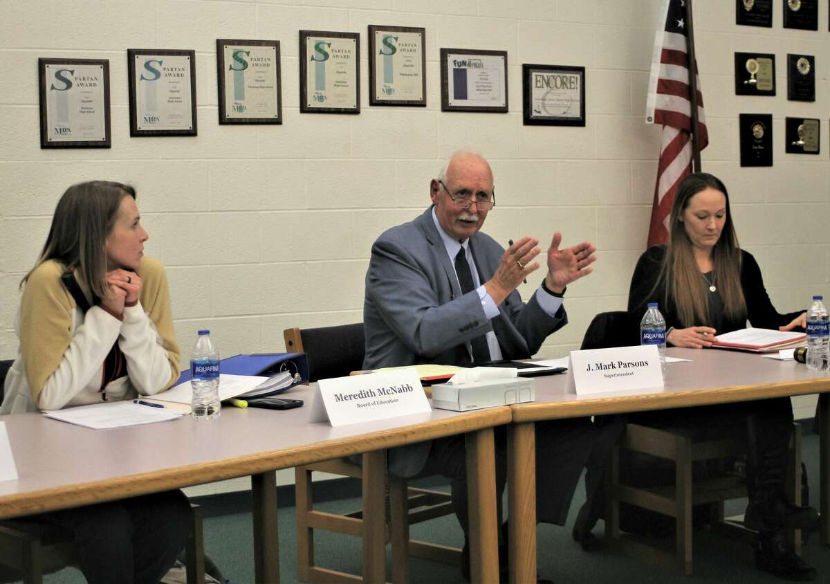 Meredith McNabb (left), Onekama Consolidated Schools board trustee; Mark Parsons, interim superintendent; and Chelle Hrachovina, board vice president, take part in a school board meeting March 13.