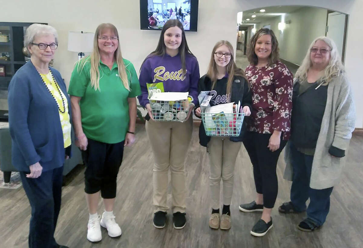 Anchor Club members Sadie Robinson  (center left) and Delaney Baker (center right), along with Pilot Club of Jacksonville member Patty Osborne (right) present a Memory Basket to representatives of Cedarhurst of Jacksonville, including resident Carol P. (from left) and Cedarhurst staff members Jody Werner and Shelly Shillings.