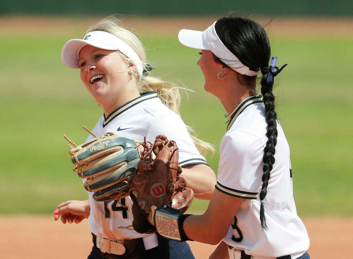 Lake Creek second baseman Madalyn Davis (14) smiles toward first baseman Alyson Higginbotham (9) after Davis’ diving play to throw out Brenham’s Kaylie Rodriguez to end the top of the first inning of a District 21-5A high school softball game at Lake Creek High School, Tuesday, March 14, 2023, in Montgomery.