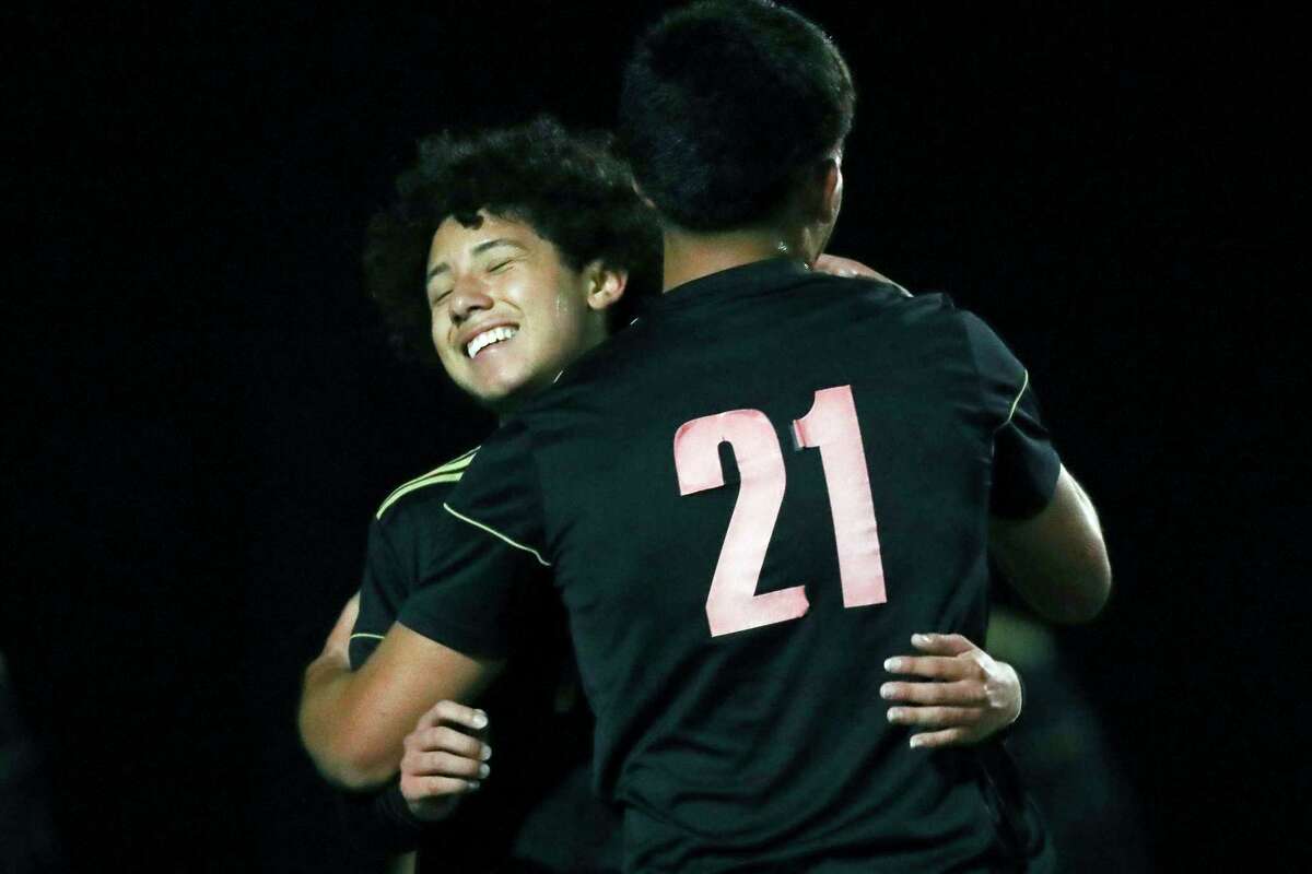 Caney Creek's Christian Claros (7) gets a hug from Mario Leon (21) after scoring a goal during the first half of a District 13-6A high school soccer match at Caney Creek High School, Tuesday, March 14, 2023, in Grangerland.