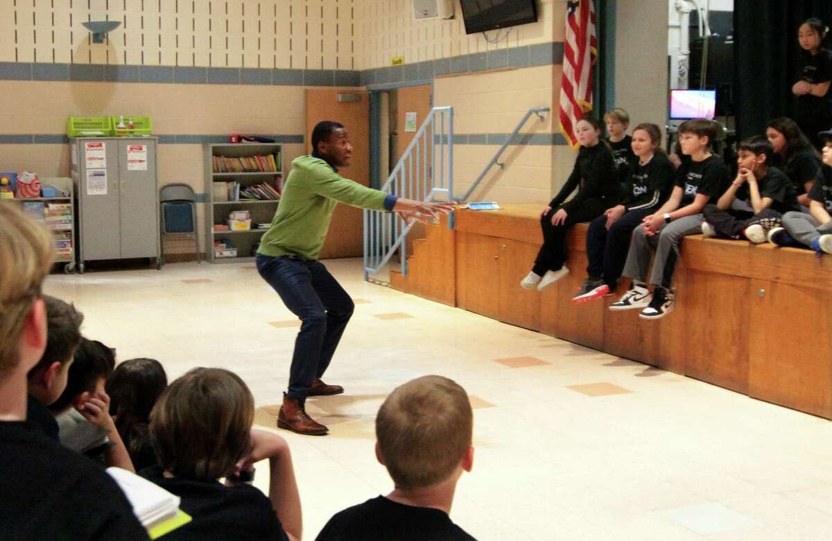 Kyle Wrentz, an original Broadway cast member of the Lion King, works with fifth-grade participants in this year's school play, Frozen, during an acting clinic at Cos Cob School in Greenwich, Conn., on Tuesday March 14, 2023. Wrentz, an original Broadway cast member of the Lion King, worked with the students to get in touch with the emotion of their characters as well as enhancing their choreography. The production of Frozen will be performed on April 3rd and 4th at 7 pm each night.