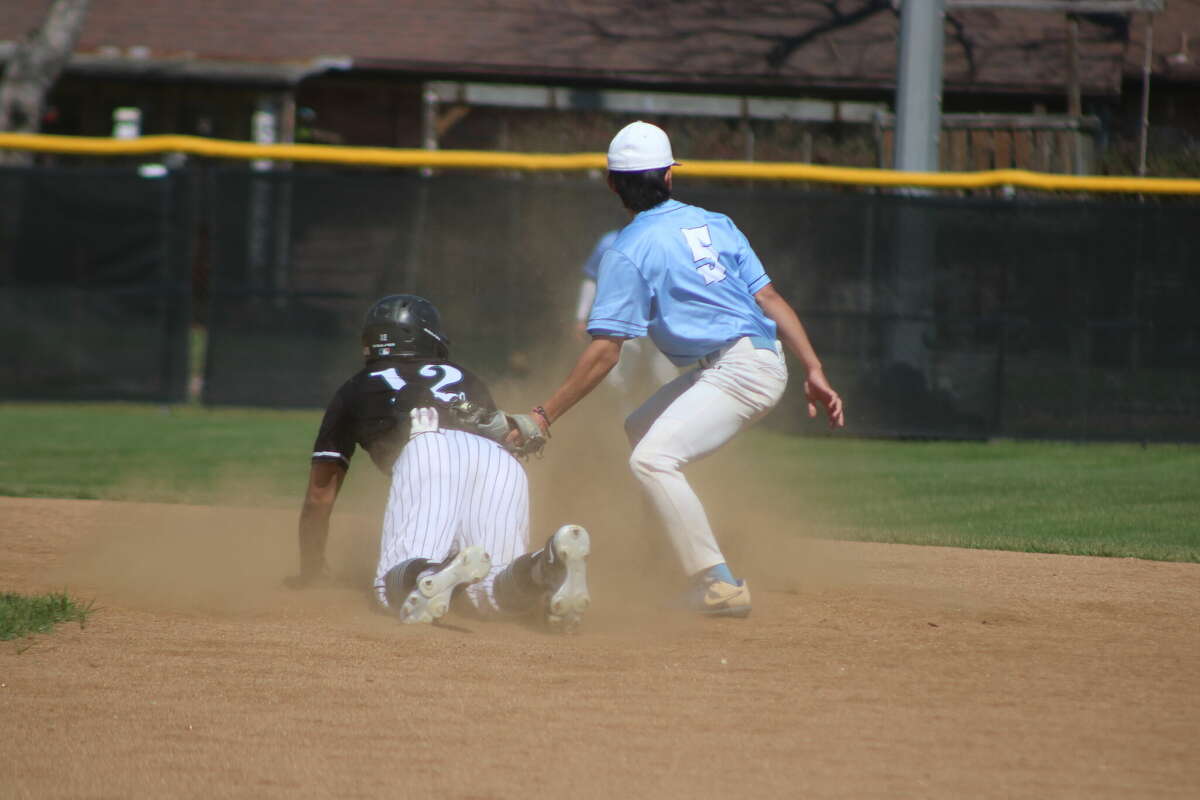 Memorial's Christian Ibarra swipes second base as Rayburn's Jasyon Molina applies the late tag during action in the fifth inning.