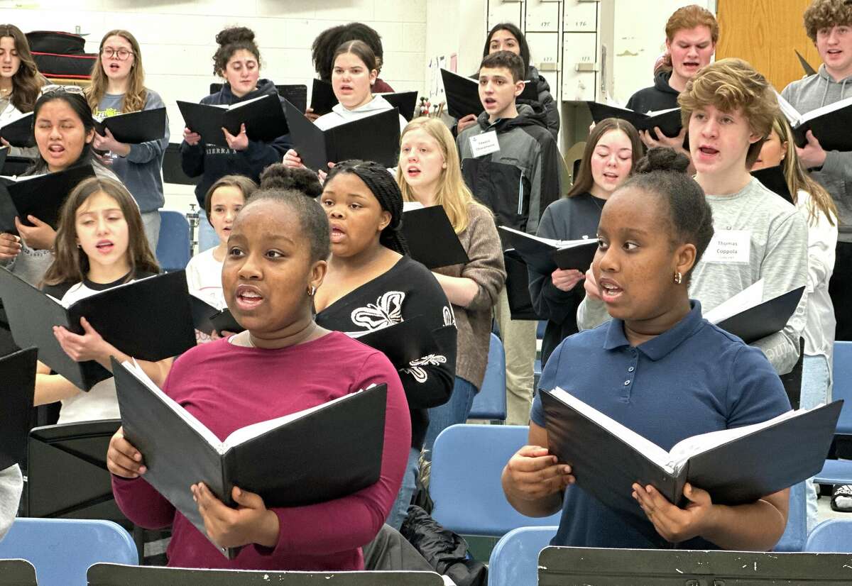 Dienna, left, and Deilyn Wilson, identical twins in 7th grade from Bridgeport, at a rehearsal of the Fairfield County Children's Choir, for the group's performance at Carnegie Hall in New York on Friday, March 17, with the Cross Border Orchestra of Ireland. 