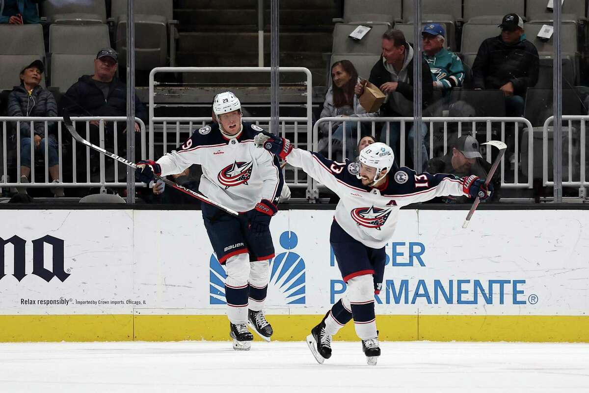 Johnny Gaudreau, right, and Patrik Laine of the Columbus Blue Jackets celebrate after Gaudreau scored the winning goal against the San Jose Sharks in overtime Tuesday.
