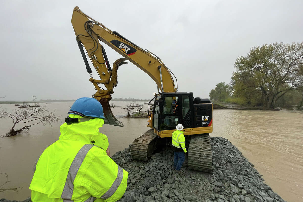 FILE - A crew works at repairing a levee rupture at the Pajaro River in Monterey County, Calif., Tuesday, March 14, 2023. Forecasters warned of more flooding, potentially damaging winds and difficult travel conditions on mountain highways as a new atmospheric river pushed into swamped California early Tuesday.