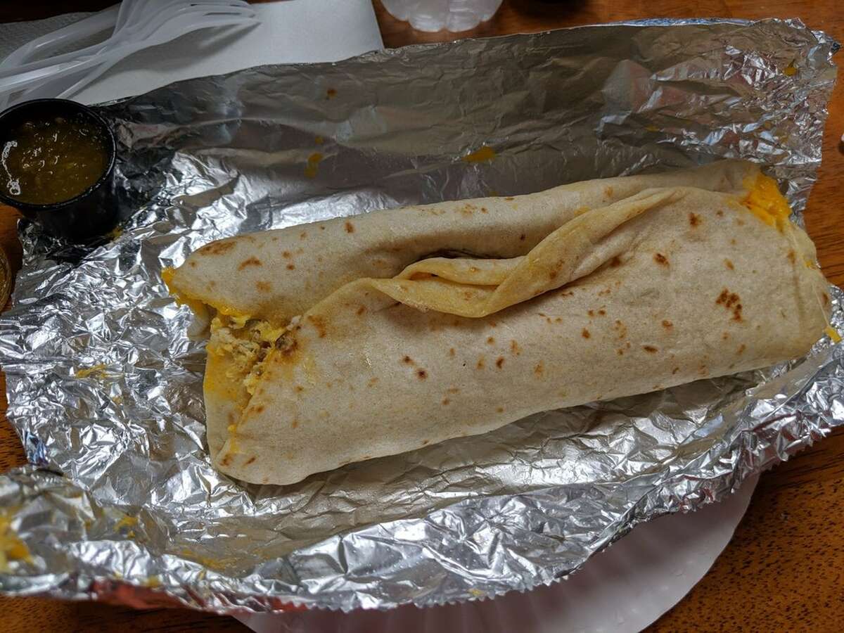A surprise burrito is simply a fresh homemade flour tortilla, refried beans, scrambled eggs, cheese, bacon and potatoes.