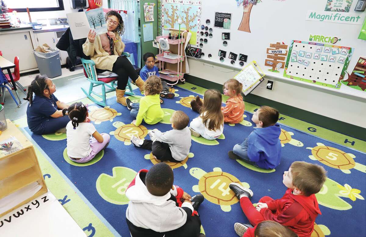 Students in the early childhood program at Gilson Brown School gather on the carpet for story time in the classroom of teacher Amber Sims.