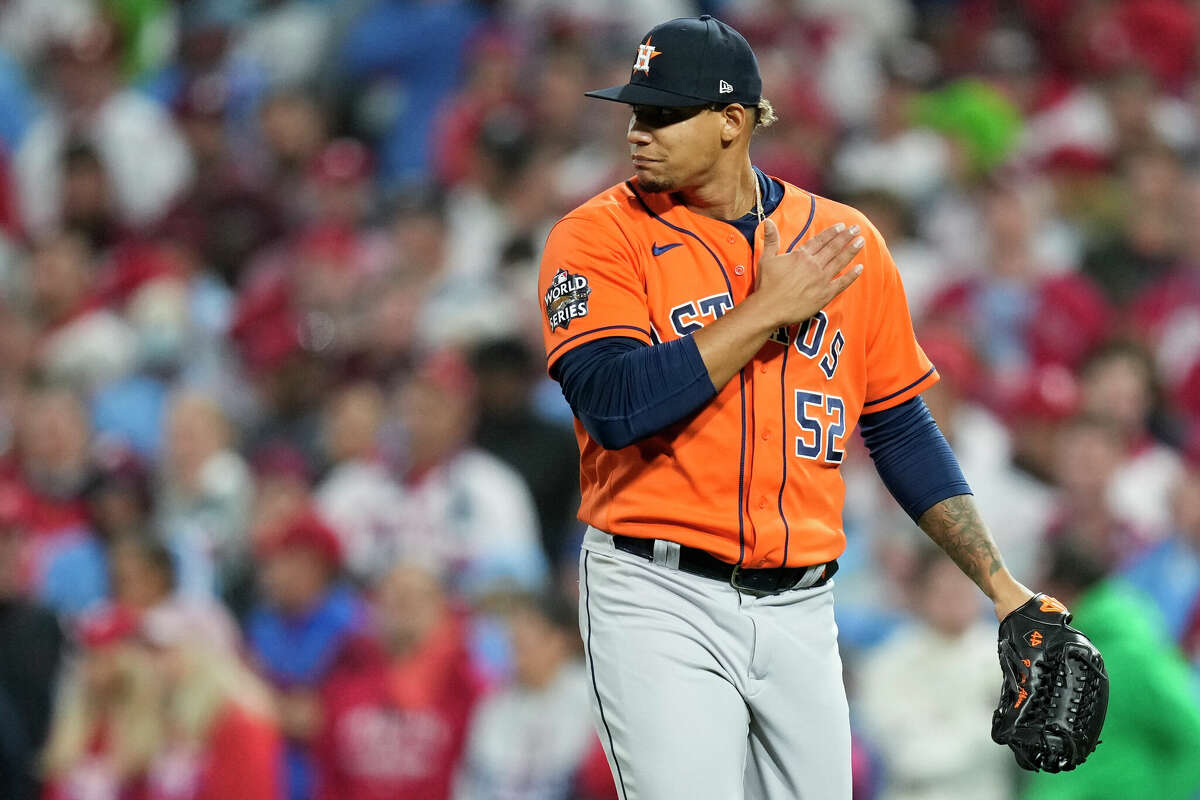 Houston Astros relief pitcher Bryan Abreu (52) pounds his shoulder as he walks off the field after getting Philadelphia Phillies Kyle Schwarber to ground out to end the sixth inning during Game 5 of the World Series at Citizens Bank Park on Thursday, Nov. 3, 2022, in Philadelphia.