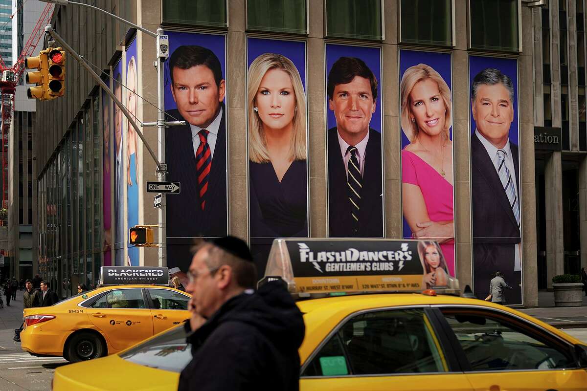 Advertisements featuring Fox News personalities, including Bret Baier, Martha MacCallum, Tucker Carlson, Laura Ingraham and Sean Hannity, adorn the front of the News Corporation building in New York City.