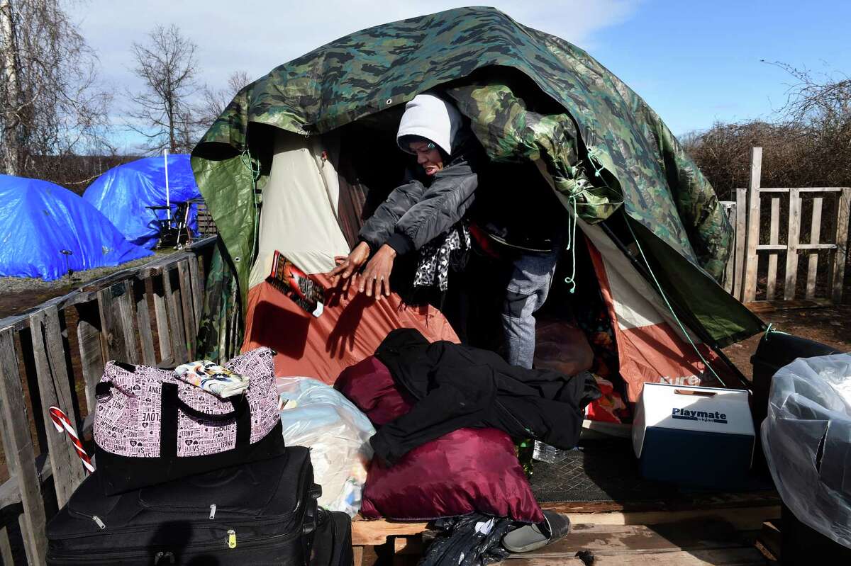 Jaquedah Williams clears out her belongings from her tent in the Tent City community along the West River in New Haven in response to an eviction notice on March 15, 2023.
