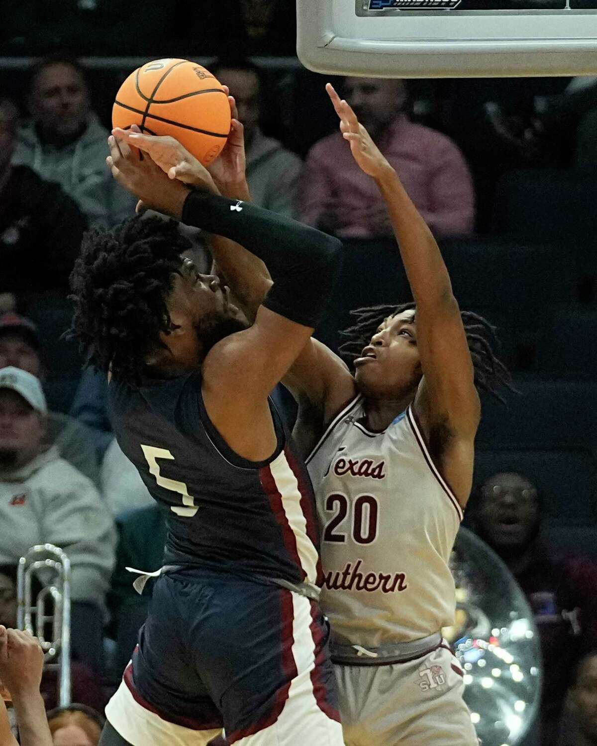 Fairleigh Dickinson's Ansley Almonor (5) is fouled by Texas Southern's Kehlin Farooq (20) as he shoots during the first half of a First Four college basketball game in the NCAA men's basketball tournament, Wednesday, March 15, 2023, in Dayton, Ohio. (AP Photo/Darron Cummings)