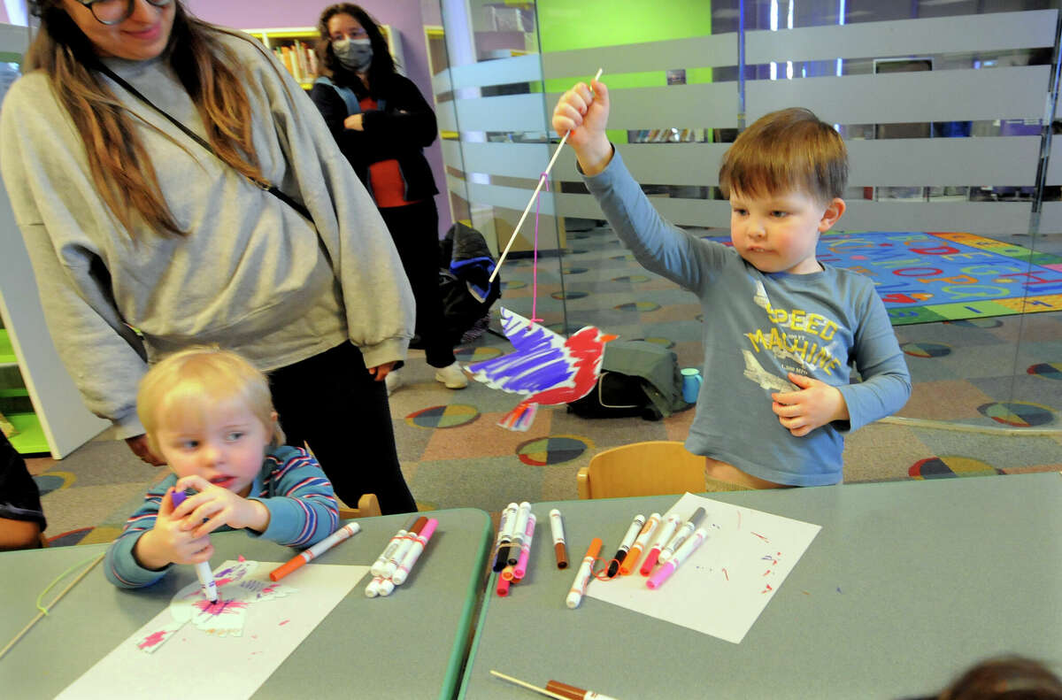Thomas Woolston, 5, Plays With A Bird Craft He Made During Danbury Library'S Story Corner: &Quot;Fly Like A Bird&Quot; Storytime Event For Children In Danbury, Conn., On Wednesday March 15, 2023. At Left Is Thomas' Little Brother Michael, 2. Children Listened To Stories About Birds Read By Children'S Librarian Christine Furlo, Learned Some Of The Names Of The Colorful Creatures, Watched A Video About A Friendship Between A Cat And A Canary And Finally Made A Craft To Celebrate Them. To Find Out About Future Events At The Library, Visit: 