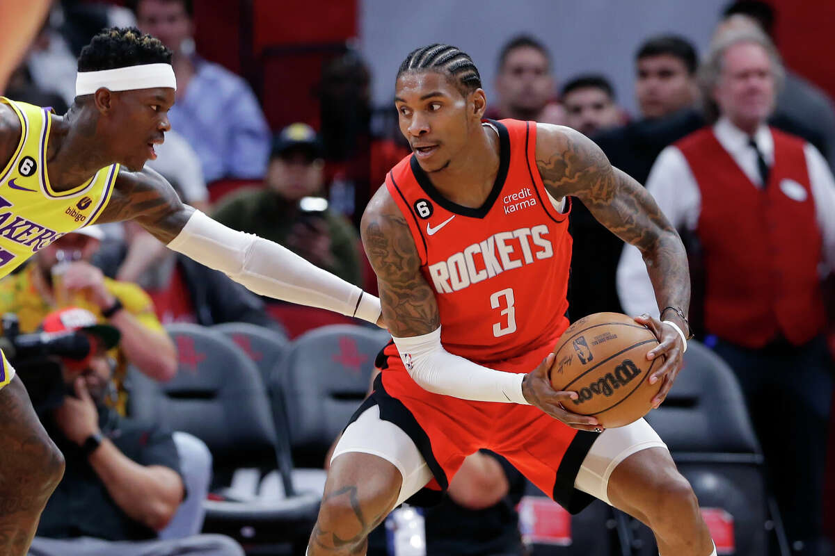 Houston Rockets guard Kevin Porter Jr. (3) looks to drive around Los Angeles Lakers guard Dennis Schroder, left, during the first half of an NBA basketball game Wednesday, March 15, 2023, in Houston. (AP Photo/Michael Wyke)