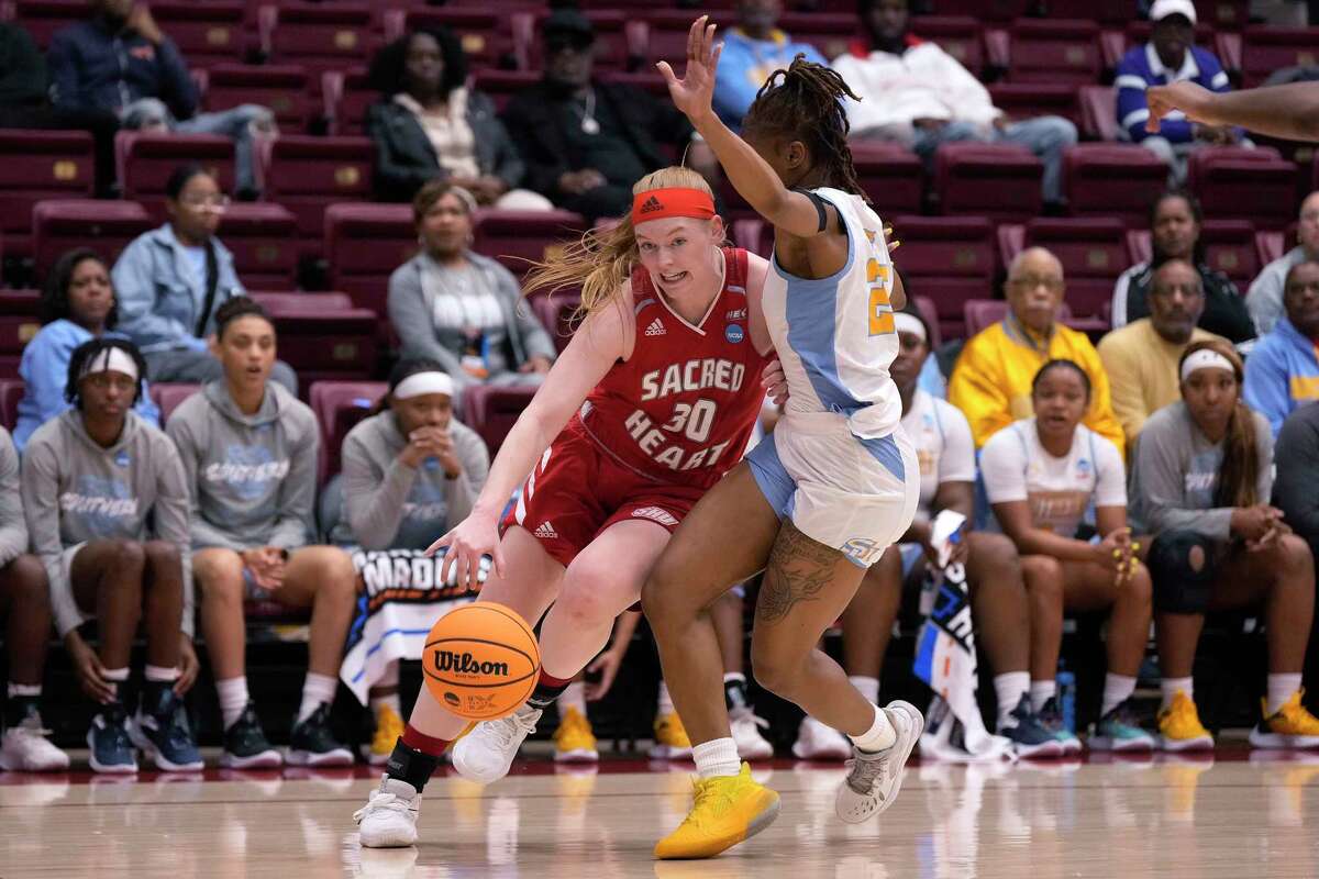 Sacred Heart guard Olivia Tucker (30) drives around Southern guard Genovea Johnson during the first half of a First Four game in the NCAA women's college basketball tournament Wednesday, March 15, 2023, in Stanford, Calif.