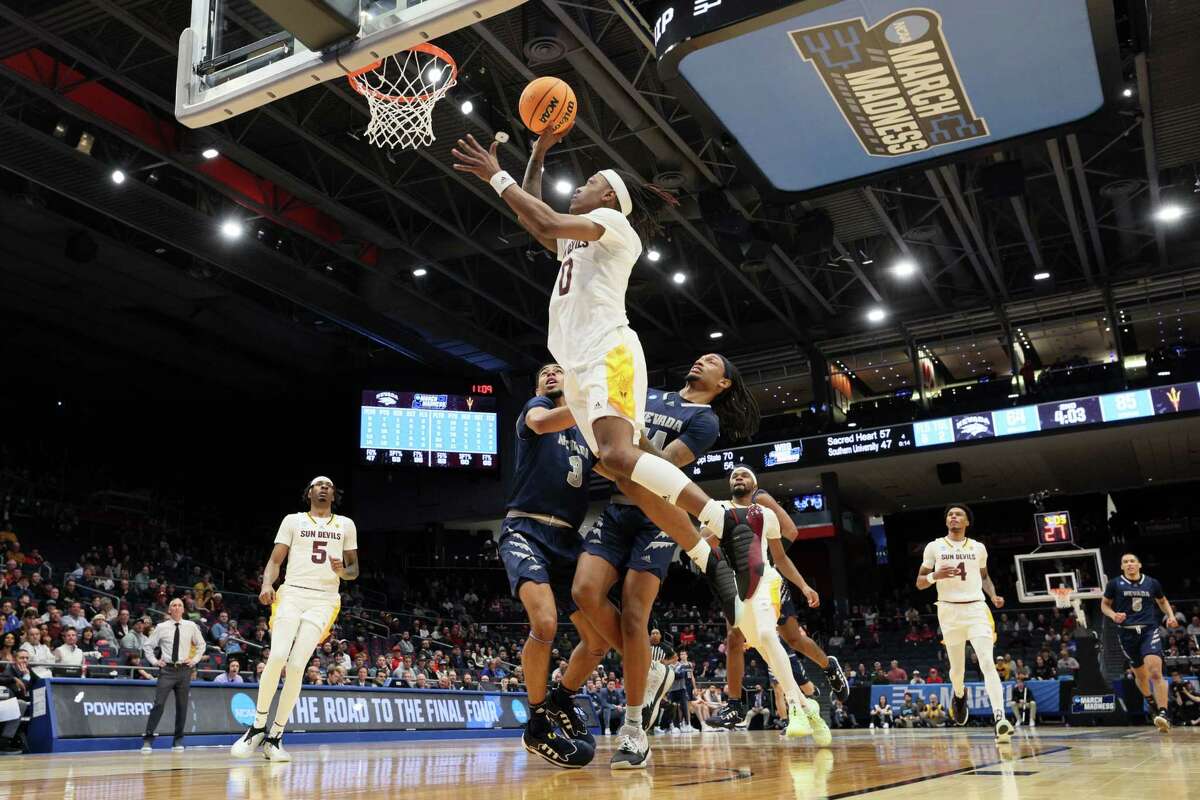 DAYTON, OHIO - MARCH 15: DJ Horne #0 of the Arizona State Sun Devils shoots against Trey Pettigrew #3 and Tre Coleman #14 of the Nevada Wolf Pack during the second half in the First Four game of the NCAA Men's Basketball Tournament at University of Dayton Arena on March 15, 2023 in Dayton, Ohio.