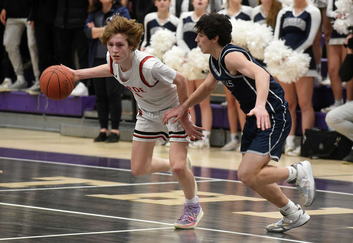 Warde's Colin Vigeant (11) drives against Staples' Adam Udell during the CIAC Div. II boys basketball semifinals at Westhill on Wednesday, March 15, 2023.