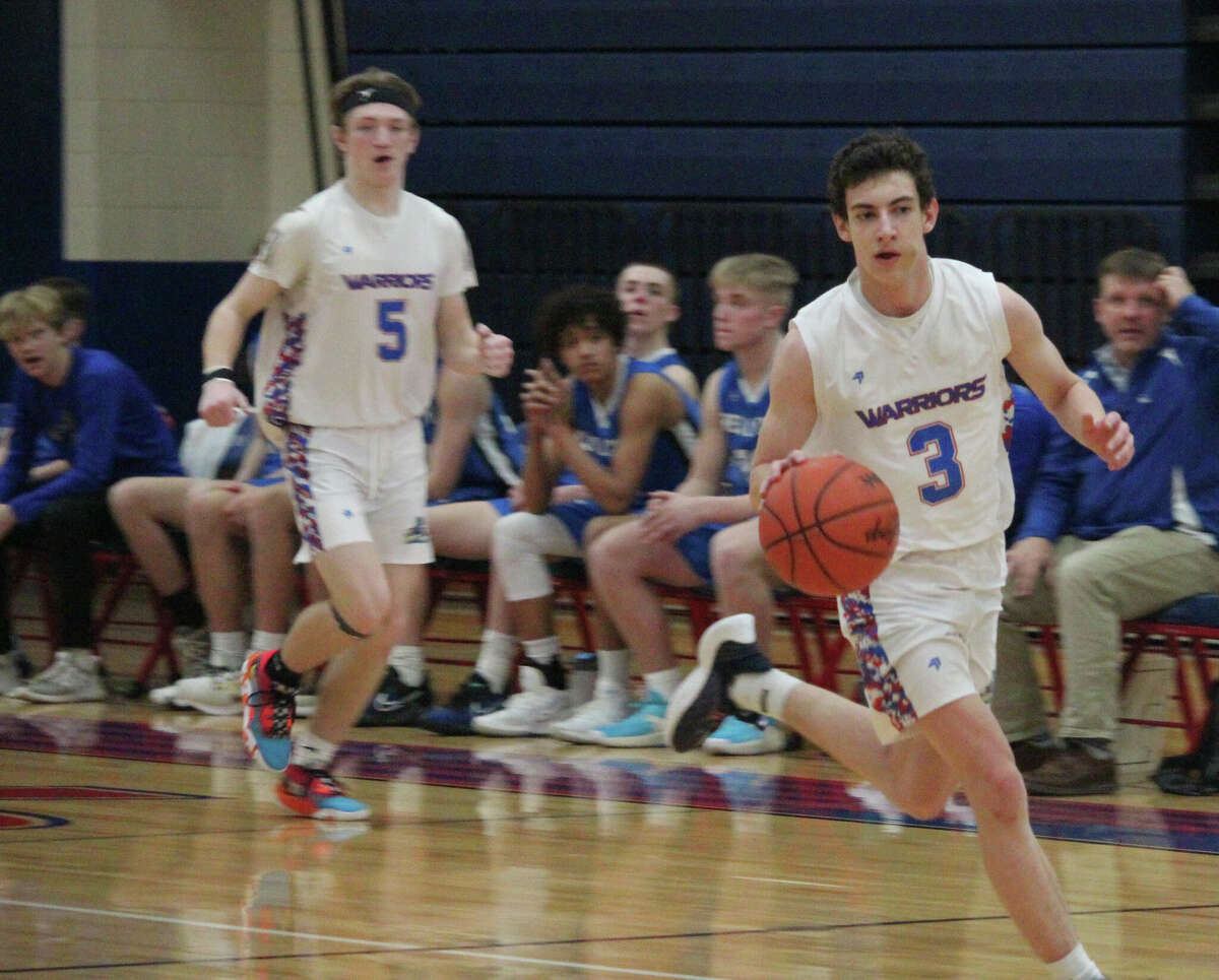 Chippewa Hills' Jordan Hansen (3), with teammate Brayden Hunt (5) looking on, takes the ball down the court during the regular season.