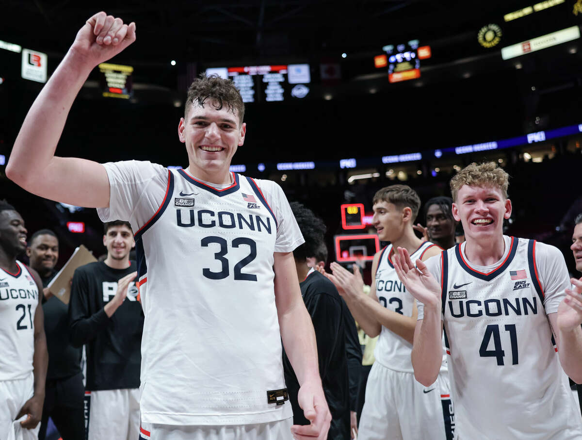 PORTLAND, OR - NOVEMBER 27: Donovan Clingan #32 of the UCONN Huskies celebrates following the game against the Iowa State Cyclones in the Phil Knight Invitational Tournament Men's Championship at Moda Center on November 27, 2022 in Portland, Oregon. (Photo by Michael Hickey/Getty Images)
