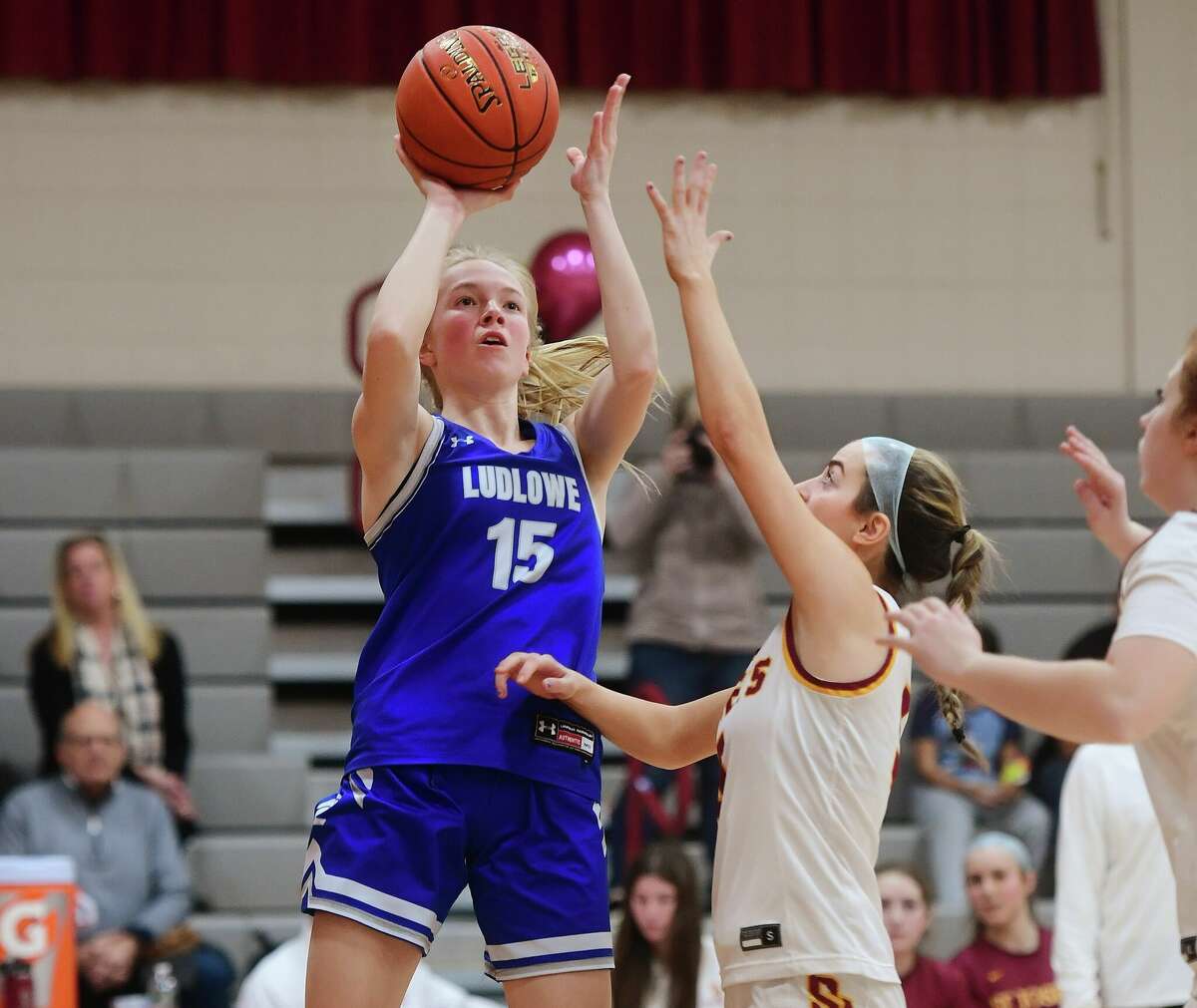 Fairfield Ludlowe's Phoebe Shostak, seen shooting over St. Joseph defender Gigi Gracia earlier this season, has stepped up for the Falcons in the CIAC Class LL tournament.