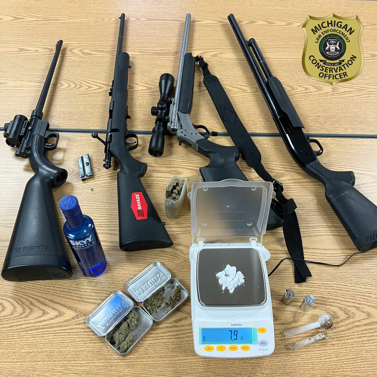 Conservation officers for Michigan DNR arrested two people driving through a northern Michigan state forest for possessing illegal firearms and drugs after conducting a traffic stop.